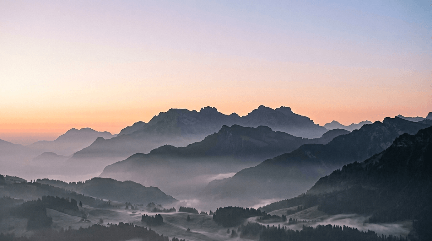 Silhouetted ridge at dawn with peach and pale blue sky—soft morning study.
