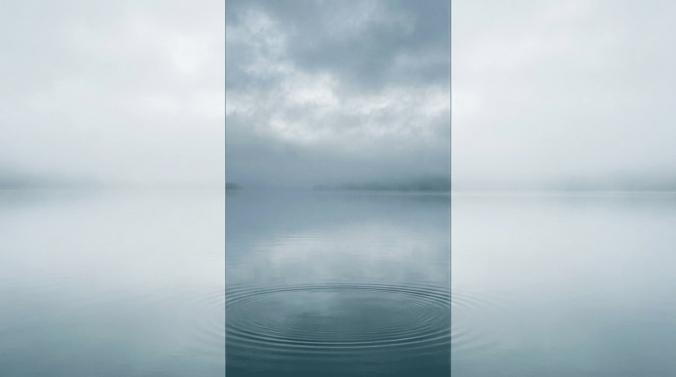 Still water under overcast mist with faint ripples—cool silver-blue editorial study.